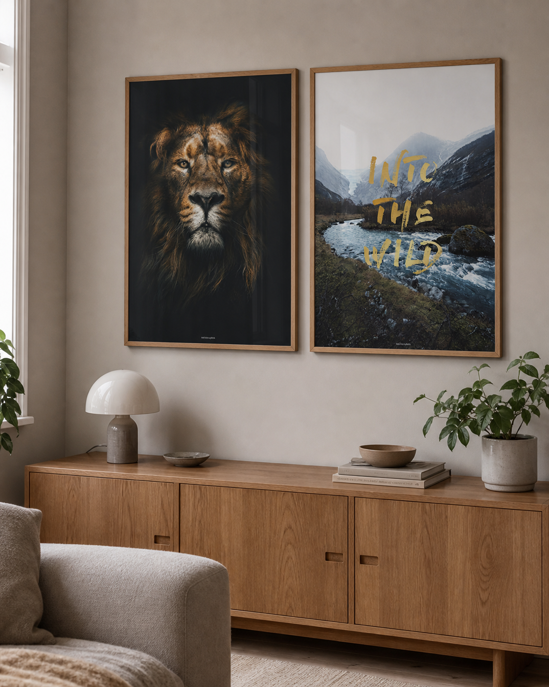 Lion King og Into the Wild plakater i matchende egetræsrammer hænger sammen over et egetræsskab i en lys dansk stue med dagslys.